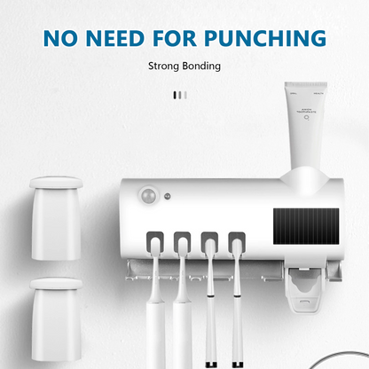 UV Light Sterilizer Toothbrush Holder Cleaner & Automatic Toothpaste Dispenser mounted on a wall with toothbrushes and cups.