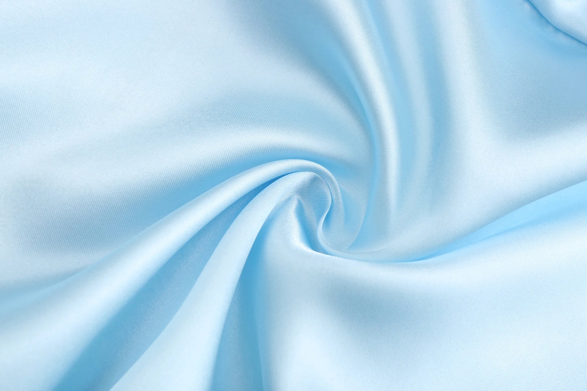 Light blue satin fabric swirled for wedding party satin robe, showcasing smooth texture and elegant drape.