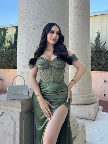 Green satin mermaid prom dress featuring sweetheart neckline, high side slit, and off-the-shoulder design.