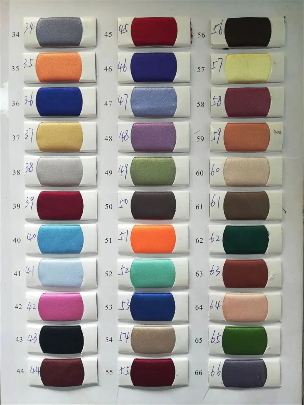 Color swatches for elegant evening dresses with 3D flowers, showcasing various fabrics and hues for customization options.