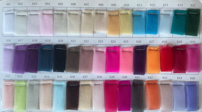 Swatch samples of various colors and fabrics including tulle, showcasing a range for formalwear and evening dresses.