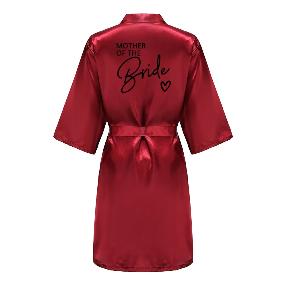 Bridesmaid satin robes in red with 'Mother of the Bride' printed on the back, elegant satin fabric.