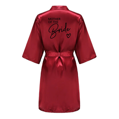 Bridesmaid satin robes in red with 'Mother of the Bride' printed on the back, elegant satin fabric.