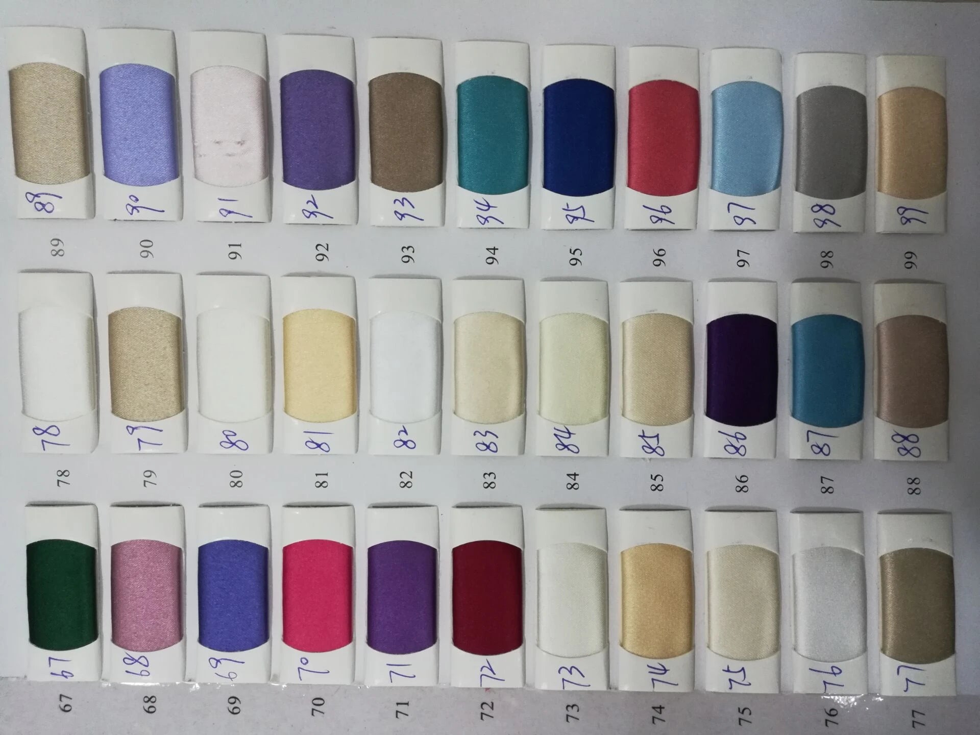 Fabric color swatches in various shades for mermaid evening dresses, showcasing satin and beading options for formal gowns.
