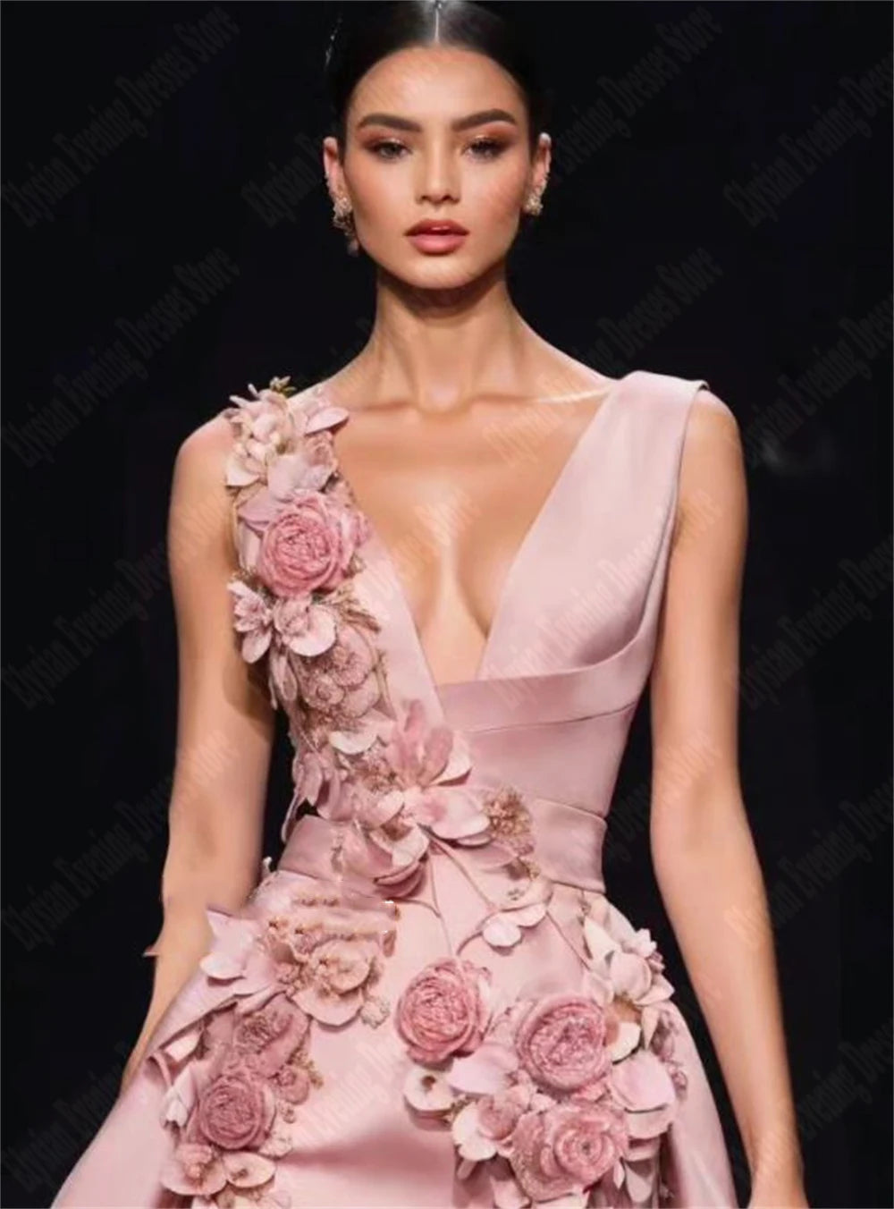 Elegant evening dresses with 3D flowers in blush pink, featuring floral appliques and a V-neck design.