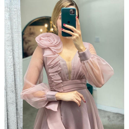 Dusty pink prom dresses featuring a V-neck, ruffles, and long sheer sleeves, perfect for wedding parties.