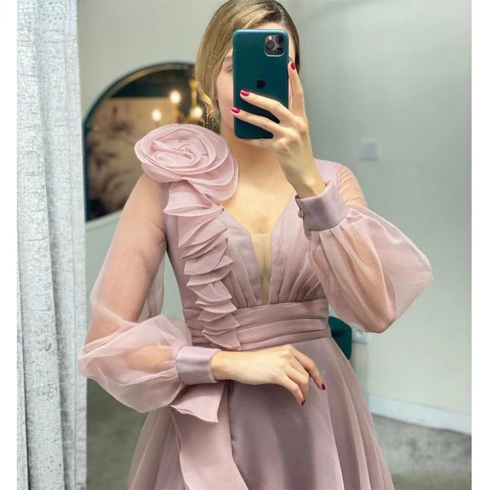 Dusty pink prom dresses featuring ruffles, a V-neck, and long sheer sleeves for elegant wedding parties.