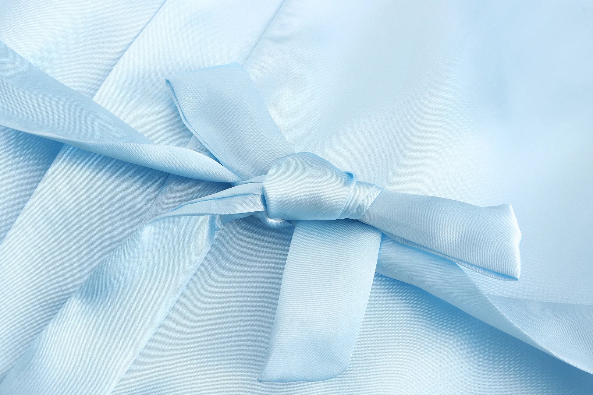 Light blue satin fabric with a tied bow detail, showcasing a wedding party satin robe design for brides and bridesmaids.