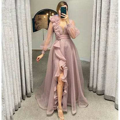 Dusty pink prom dresses featuring sheer long sleeves, a V-neckline, and elegant ruffles in an A-line silhouette.