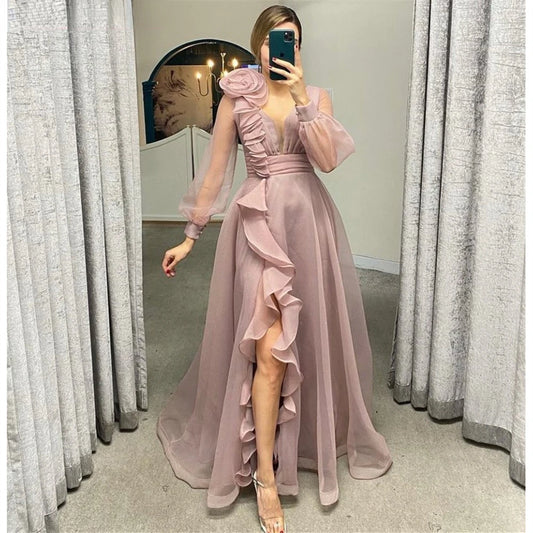 Dusty pink prom dresses featuring sheer long sleeves, a V-neckline, and elegant ruffles in an A-line silhouette.