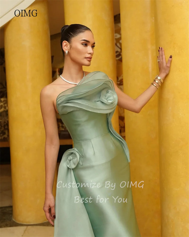 Model showcasing the OIMG green strapless mermaid prom gown with elegant floral details and a sleek satin finish.