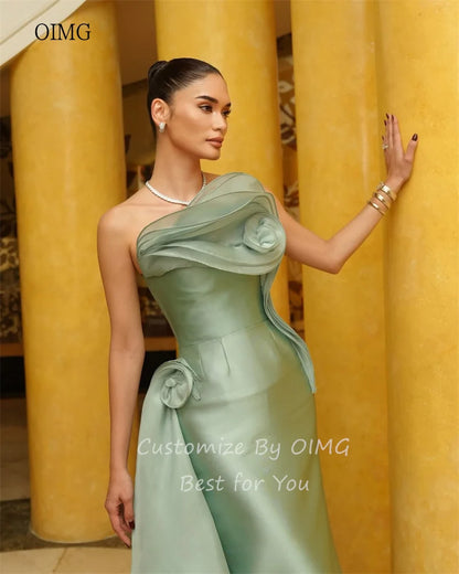 Model showcasing the OIMG green strapless mermaid prom gown with elegant floral details and a sleek satin finish.