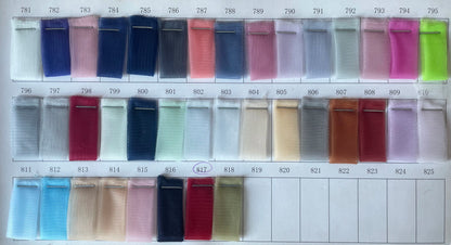Swatches of various tulle fabric colors for RFYR asymmetrical prom gown customization options.