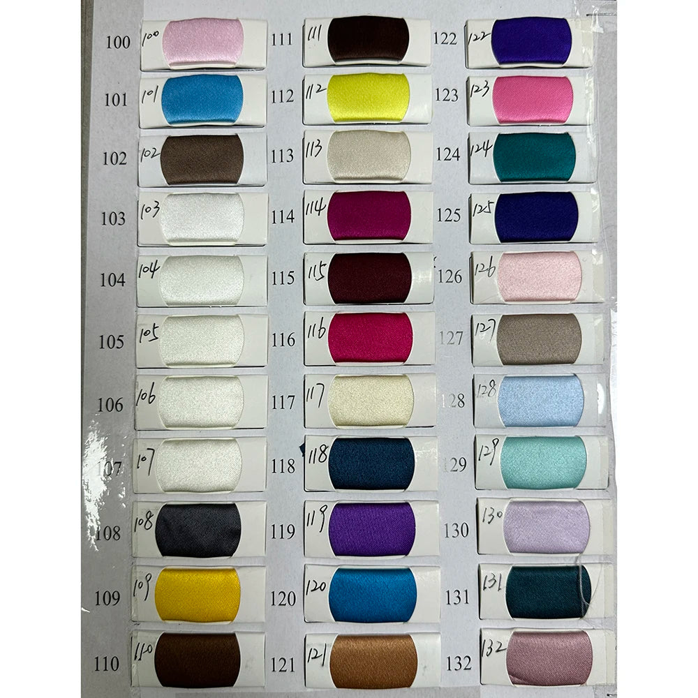 Color swatch chart with various fabric samples for evening dresses showcasing diverse shades and textures.