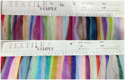 Textile sample card displaying various fabric swatches in multiple colors and textures for design selection.