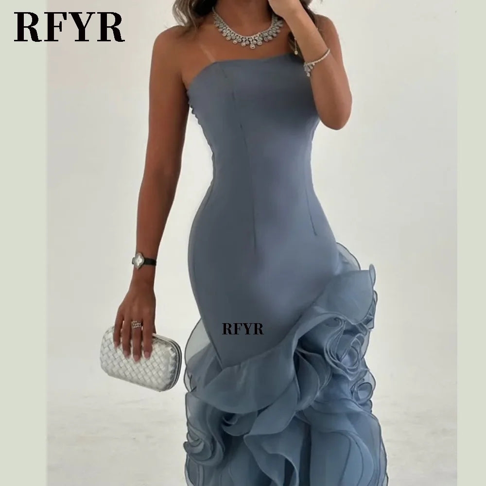 Asymmetrical prom gown featuring tiered layers and a mermaid silhouette, perfect for formal occasions.